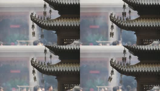 上海静安寺建筑屋檐上的神仙和野兽，御黄屋顶装饰，屋檐下的风铃随风摇摆，高速录像，慢镜头。高清在线视频素材下载