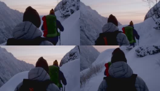 冬天的山探险。小径上的年轻夫妇。日落高清在线视频素材下载