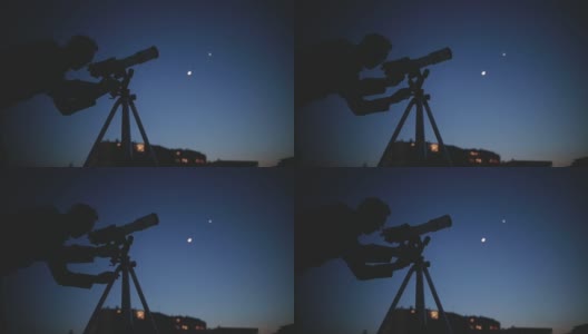 天文学家用望远镜观察星星和以模糊的城市灯光为背景的月亮。高清在线视频素材下载