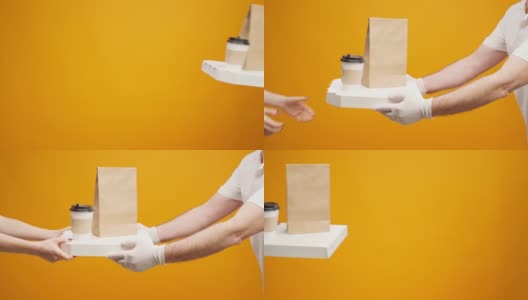 黄色工作室背景下，人们的手相互传递着装着食物的盒子高清在线视频素材下载