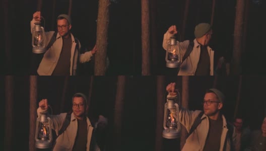 一小群朋友提着灯笼在森林里闲逛。高清在线视频素材下载