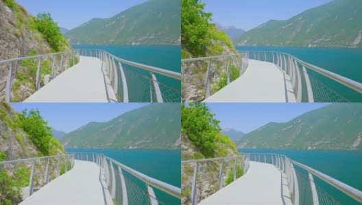 路悬在山上的岩石上，通往阿尔卑斯山的湖泊高清在线视频素材下载