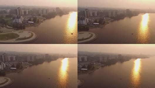 鸟瞰城市和湖泊被森林大火的浓雾所覆盖高清在线视频素材下载