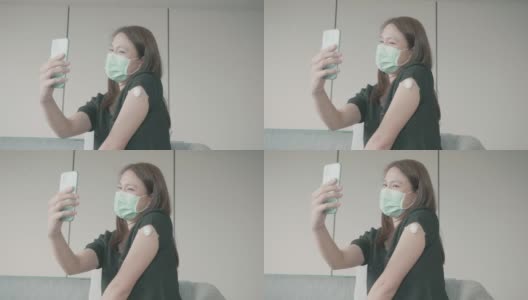 4K视频:一名妇女戴着防护口罩在医生办公室打疫苗时自拍高清在线视频素材下载