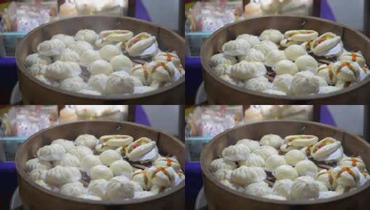 在泰国曼谷的一家小餐馆的中国步行街上出售的刚煮好的馒头和饺子高清在线视频素材下载