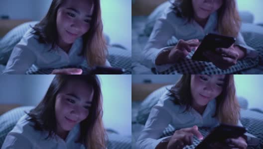 女人晚上在床上玩智能手机高清在线视频素材下载