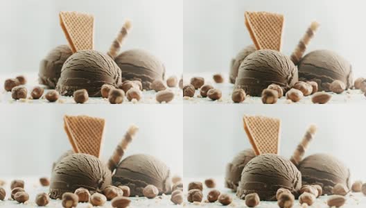 巧克力冰淇淋，旁边有榛子，上面有装饰高清在线视频素材下载