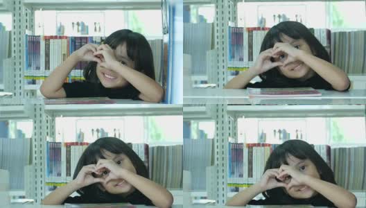 亚洲女孩在图书馆，心标志高清在线视频素材下载