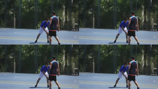 年轻的亚洲篮球运动员在户外球场高清在线视频素材下载
