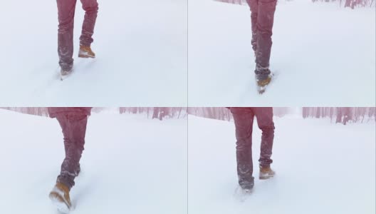 穿着靴子走路的脚在一个冬天的风景中慢动作，一个冬天在山上散步，度假旅游，飘落的雪花高清在线视频素材下载