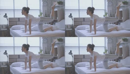 亚洲女性早上在床上锻炼，她觉得精神焕发。高清在线视频素材下载