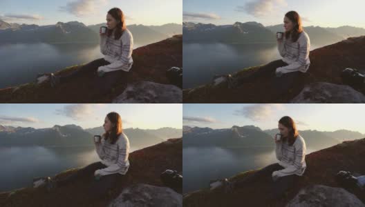 在Senja山上坐着喝茶的女人高清在线视频素材下载