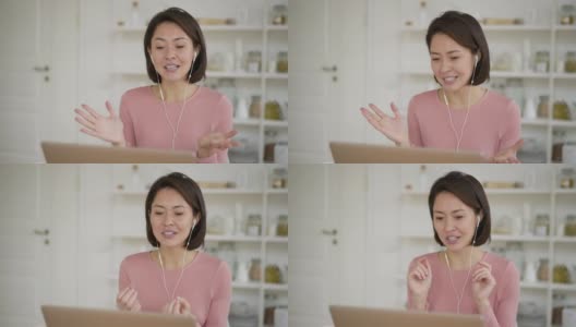 亚洲商务女性使用笔记本电脑进行视频通话，通过网络摄像头进行在线聊天，民族女性在家中进行远程聊天工作，新冠肺炎疫情隔离期间进行在线会议高清在线视频素材下载