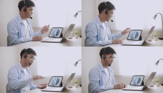 亚洲商人戴上耳机在笔记本电脑上进行视频会议高清在线视频素材下载