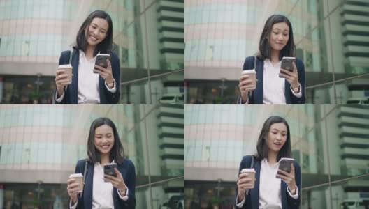 年轻的亚洲女性办公室经理在商业区用智能手机输入社交媒体信息。成功。业务人员。技术。高清在线视频素材下载