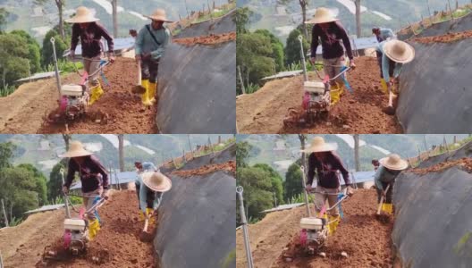 亚洲男性农民用手摇拖拉机在山坡上犁地高清在线视频素材下载