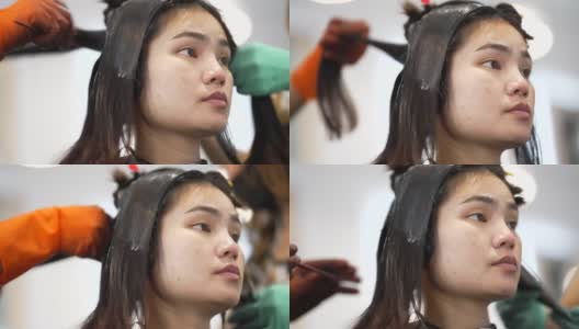 亚洲妇女在美容院，她卷头发和拉直头发。高清在线视频素材下载