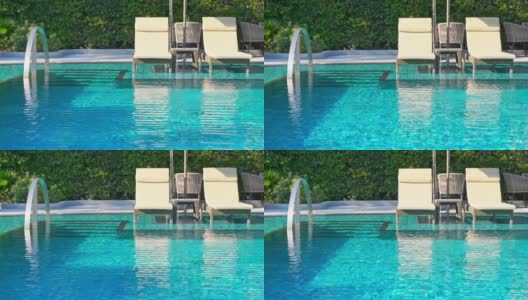 美丽的户外游泳池在酒店度假区靠近大海，为旅游度假高清在线视频素材下载