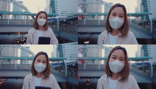 在城市里，女商人戴着防护面具。高清在线视频素材下载