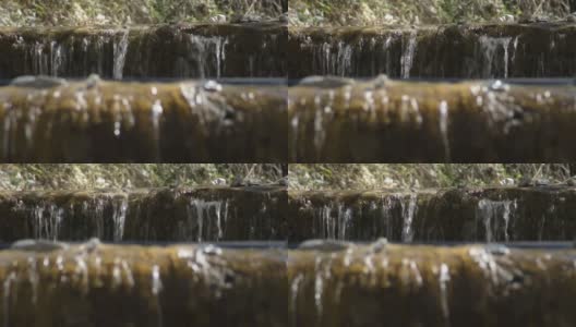 河水在小瀑布中流淌高清在线视频素材下载