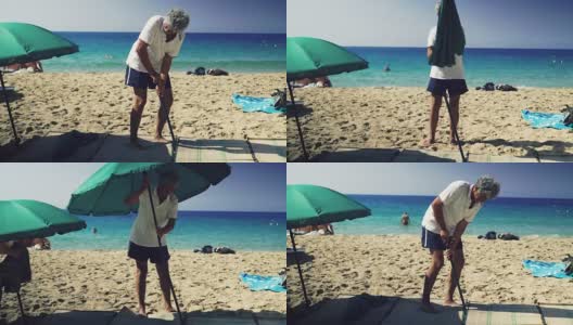 一名男子正在撑沙滩伞高清在线视频素材下载