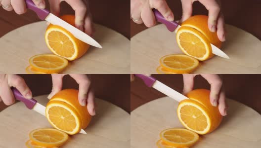 在切菜板上切新鲜橙子的女人高清在线视频素材下载
