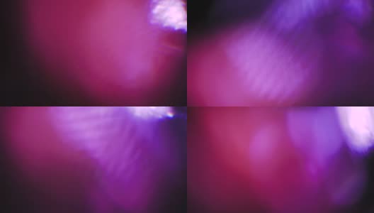 旋转抽象的紫罗兰散景。神奇的光泄漏高清在线视频素材下载