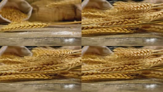 金色的麦秆落在古老的木制背景上，慢镜头高清在线视频素材下载