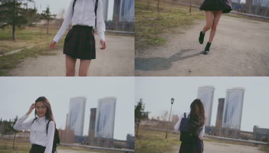 笑着的亚洲女孩穿着漂亮的制服在放学后沿着小巷跳高清在线视频素材下载