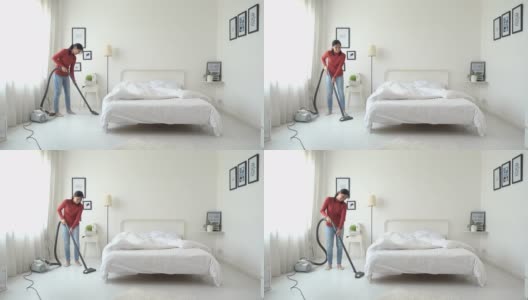 亚洲女人用吸尘器打扫房间高清在线视频素材下载
