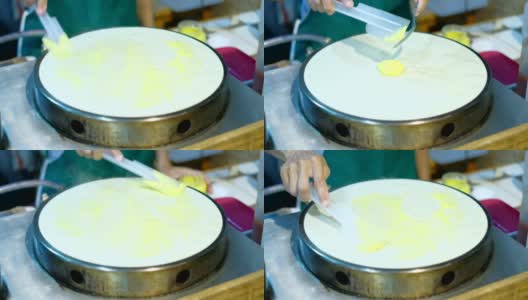 厨师将香蕉山药倒入牛奶煎饼中。泰国的街头食品。高清在线视频素材下载