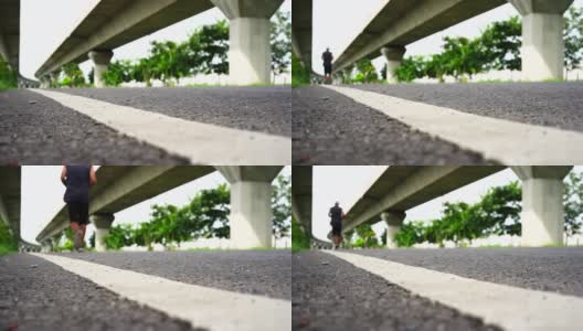 在柏油路上奔跑的男人白色的边缘线条高清在线视频素材下载