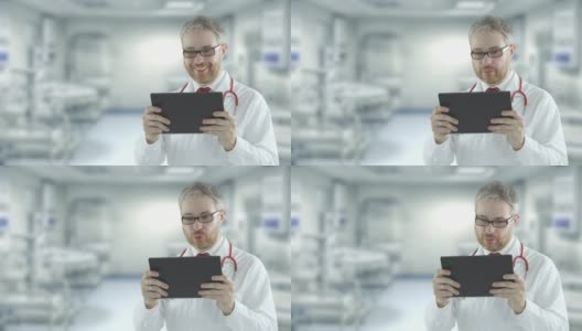 开朗的医生使用便携式平板电脑与患者进行远程医疗交流。用红色相机拍摄高清在线视频素材下载