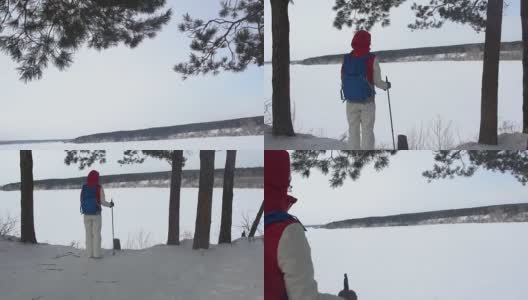 背着背包在山里徒步旅行的女孩。天气寒冷，山上有雪。冬季徒步旅行。一个背着双肩包的女人在欣赏冬季群山的景色。生活方式高清在线视频素材下载