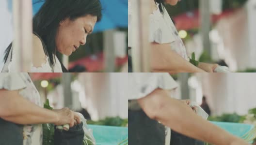 一位泰国老妇人正在泰国当地市场购买食物和蔬菜高清在线视频素材下载