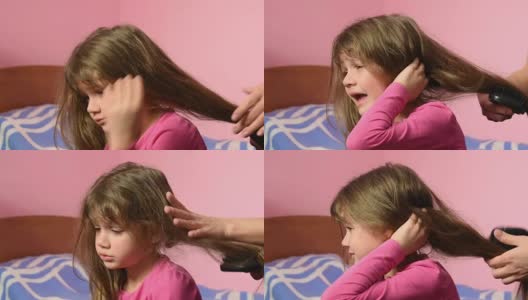 妈妈给这个女孩梳头时，她很伤心高清在线视频素材下载