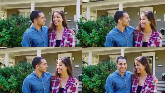 微笑的夫妻站在家门口的肖像高清在线视频素材下载