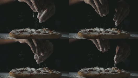 在慢镜头中，女人用手往披萨上撒面粉高清在线视频素材下载