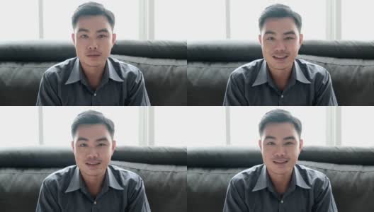亚洲男子教师通过笔记本电脑视频会议或视频电话他在家工作时对他的学生微笑与冠状病毒或COVID - 10情况。高清在线视频素材下载