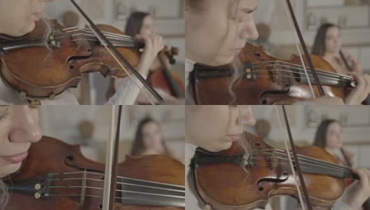 女小提琴家特写演奏在家中与大提琴二重奏高清在线视频素材下载