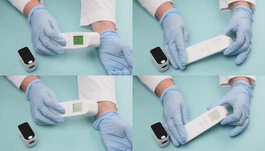 戴着蓝色乳胶手套的医生用非接触式温度计测量手腕上的体温高清在线视频素材下载