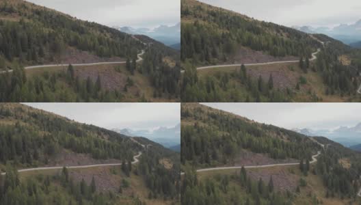 航拍的意大利阿尔卑斯山的山路上，一对夫妇骑着冒险摩托车高清在线视频素材下载