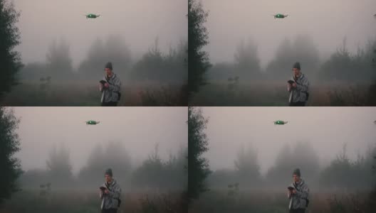 一名男子在清晨的浓雾中发射了一架无人机。高清在线视频素材下载