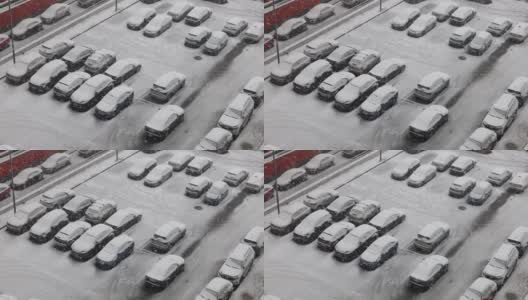 冬天的一天，雪花轻柔地飘落在停着的汽车上高清在线视频素材下载