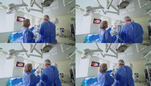 创新技术的外科手术。医学专家在机器人手术过程中使用特殊设备，以临床手术过程医疗监控为背景。高清在线视频素材下载