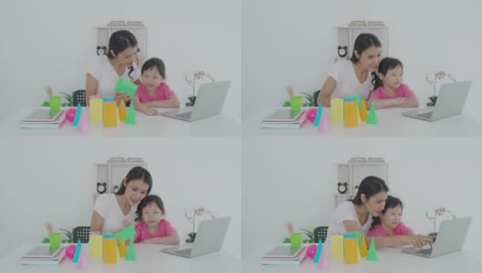 亚洲女学生与母亲视频会议电子学习与教师计算机学习几何形状在家教学。在家教育和远程学习，在线，教育和互联网。高清在线视频素材下载