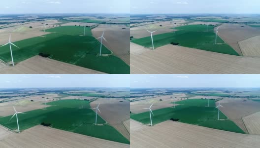 麦田里矗立着风力发电机。鸟瞰图高清在线视频素材下载