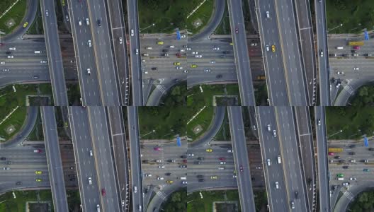高速公路交叉口鸟瞰图与繁忙的城市交通在道路上超速行驶。跨越式运输桥梁高清在线视频素材下载