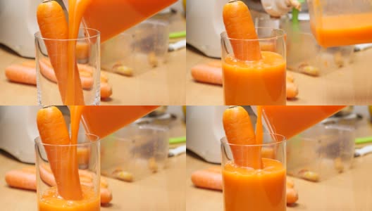 将榨好的胡萝卜汁倒入玻璃杯中。高清在线视频素材下载