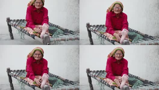 坐在Charpai上的老妇人高清在线视频素材下载